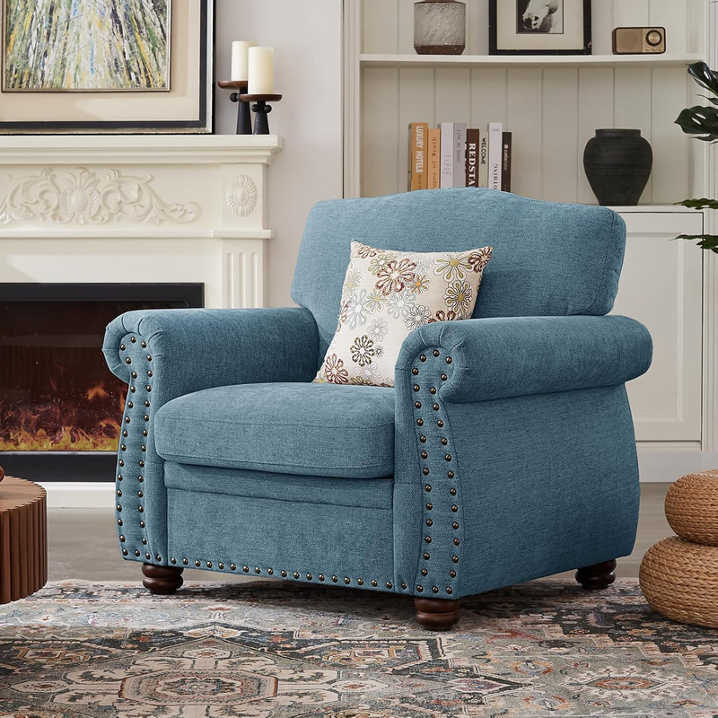 Living room set including sofa and two armchairs arranged in a large room with rug and shelves.